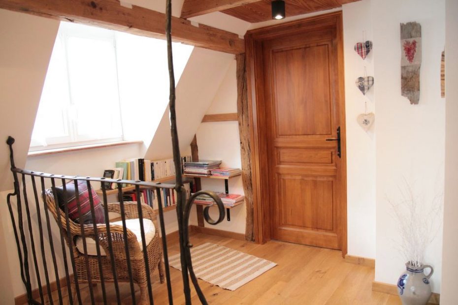 Le coin lecture à l'étage avec la balustrade en fer forgé